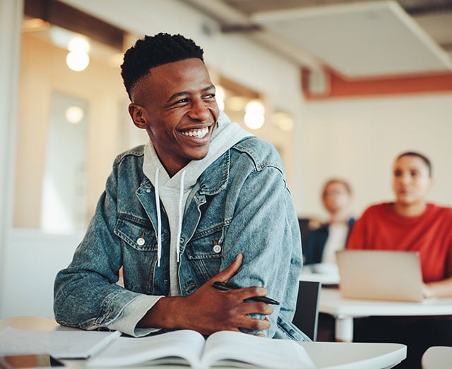 A student is smiling because he received a Tennessee scholarship from Leaders Education Foundation.